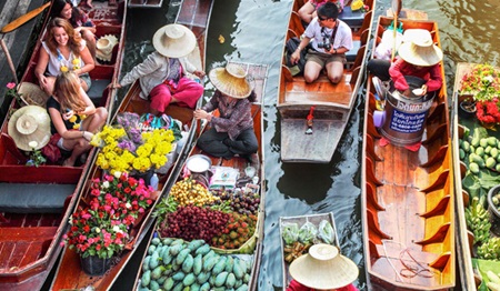 Crossing cultures: The Damnoen Saduak floating market in Ratchaburi Province, Thailand. This photo is one of the 150 on display at the exhibition. 