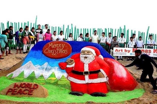 
A giant 27-foot-long sand-and-tomato Santa Claus installation, crafted by sculptor Sudarsan Pattnaik, rang in Christmas in Odisha on Sunday, as revellers flocked to the Gopalpur beach to get a glimpse of the artwork. Pattnaik claimed his creation is the worlds biggest tomato and sand installation of Santa Claus, which weighs 1.5 tonnes and is 60-feet wide. Here is a picture of a sand art made in Puri. (PTI)
