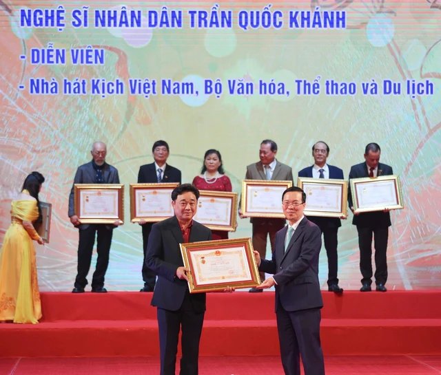 
Peoples Artist Tran Quoc Khanh receives the title bestowed by the President (Photo: VNA)
