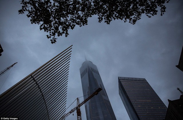 One World Trade Center is seen through early morning clouds on September 11, 2015 in New York City