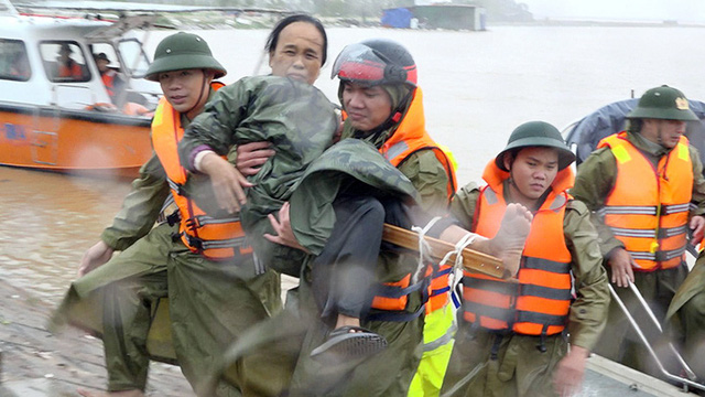 
An injured woman is taken to hospital by local police officers.
