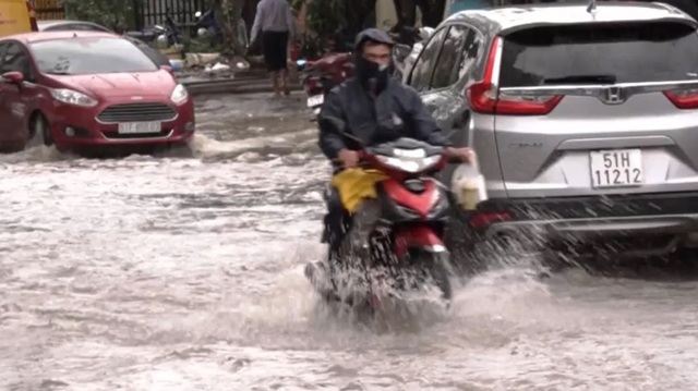 Mưa lớn kéo dài 4 giờ, nhiều tuyến đường ở TP Hồ Chí Minh ngập như sông - Ảnh 1.