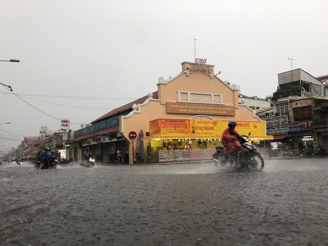 Người dân TP Hồ Chí Minh “bơi” trên đường sau trận mưa lớn hơn 3 giờ liền - Ảnh 1.