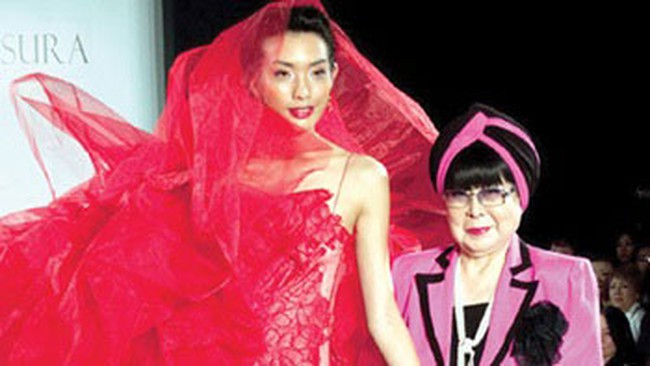 Crimson creation: Japanese fashion designer Yumi Katsura is seen with a model during a show featuring her collection. — Photo courtesy of Multimedia JSC