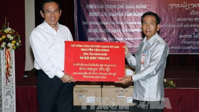 Minister-Head of the Government Office Nguyen Van Nen (left) presents 50 sets of computers to Khammouane province. (Credit: VNA)