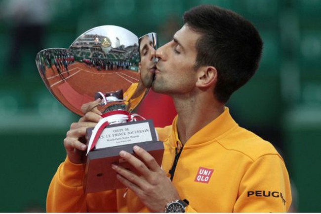 Novak Djokovic of Serbia kisses his trophy after defeating Tomas Berdych of Czech Republic in their final match of the Monte Carlo Tennis Masters tournament in Monaco