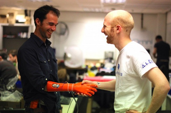 Joel Gibbard (right) using his Open Bionics hand