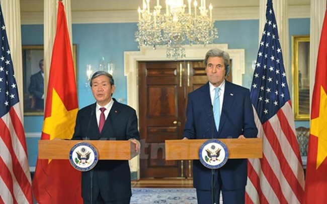 John Kerry (R) and Dinh The Huynh at a press conference