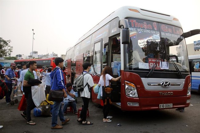 People board a coach at the Eastern Terminal, HCM City. There are now more buses with beds operating out of the terminal, but many have more than permitted and lack safety equipment (Photo: VNA)