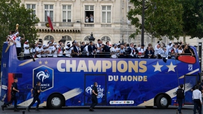 France's national soccer team players take pictures with their mobile phones as they celebrate with teammates and the trophy on the roof of a bus while parading down the Champs-Elysee avenue after winning the Russia 2018 World Cup final football match, in Paris, France, on July 16, 2018. (Photo: Pool via Reuters)