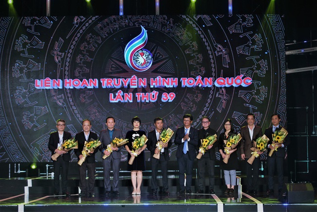 A representative of the organising board presents flowers to the broad of judges at the opening ceremony of the 39th edition of the National Television Festival