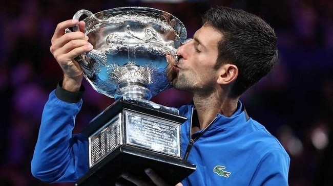 Serbia's Novak Djokovic kisses his trophy after winning the match against Spain's Rafa Nadal. (Reuters)