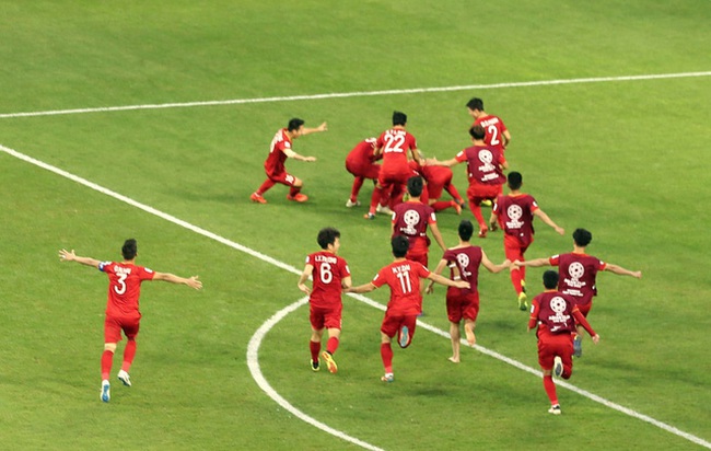Striker Nguyen Cong Phuong celebrates with teammates after equalising the score for Vietnam.