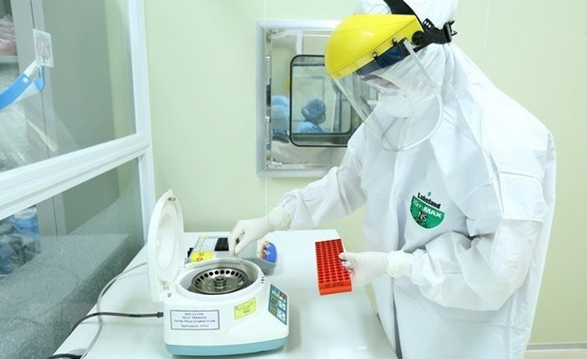 A medical worker handles samples taken for COVID-19 testing (Photo: VNA)