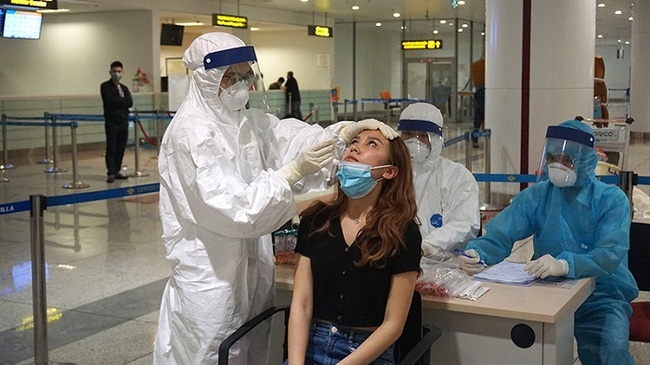 A medical staff member takes a sample for COVID-19 testing at Noi Bai International Airport.