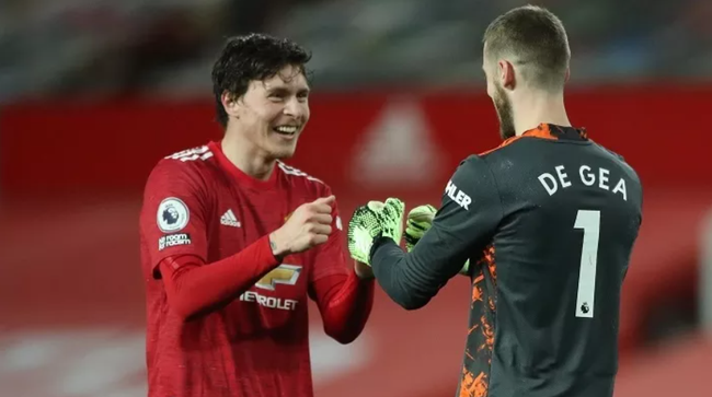 Manchester United's David de Gea and Victor Lindelof celebrate their fifth goal scored by Daniel James. (Photo: Pool via Reuters)