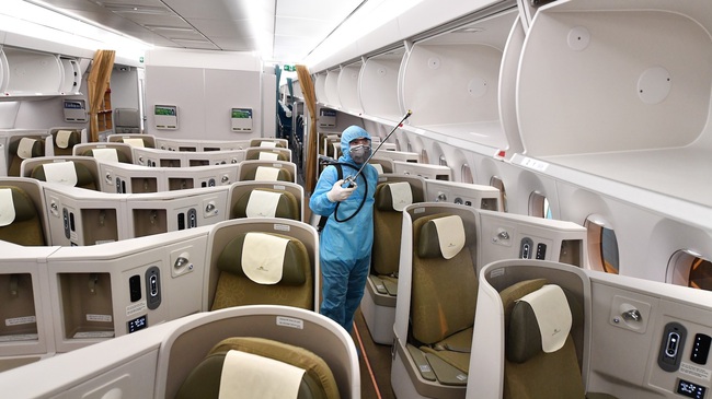 A worker disinfects an airplane to prevent the spread of the coronavirus.