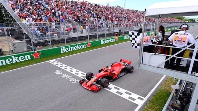 Ferrari's Sebastian Vettel passes the chequered flag to win the race. (Photo: Pool via Reuters)