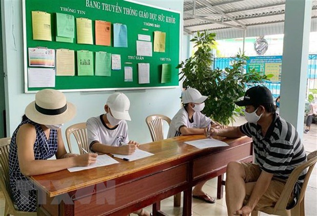 People returning to HCM City from Da Nang city fill in medical declaration forms at the Thu Duc district Health Centre (Photo: VNA)