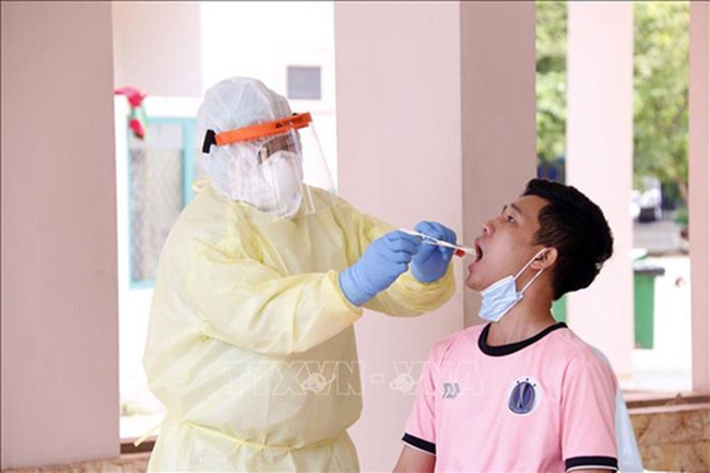 A Vietnamese students having his sample taken by Lao medical staff