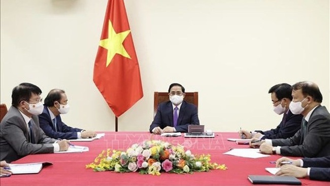 Prime Minister Pham Minh Chinh (middle) in the phone talks (Photo: VNA)