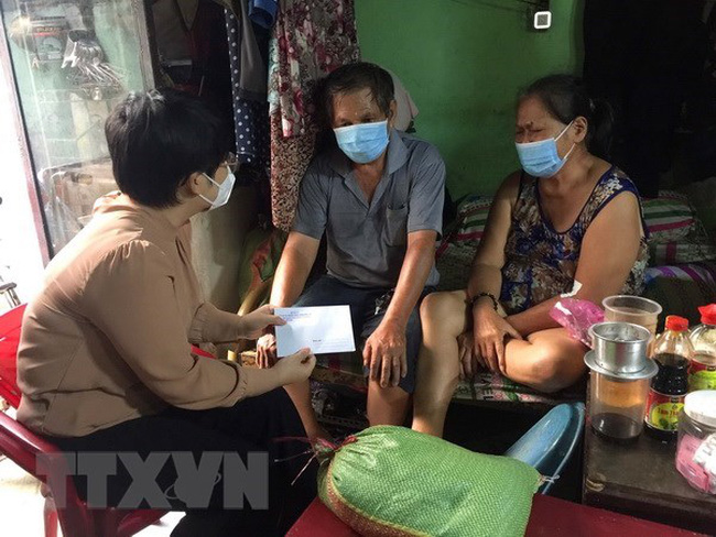 Handing over gifts to a family hit by COVID-19 in Ho Chi Minh City (Photo: VNA)