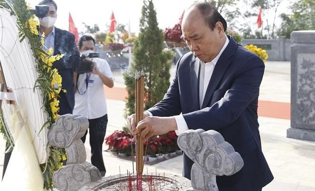 State President Nguyen Xuan Phuc on February 17 offers incense and flowers in tribute to late Acting President Huynh Thuc Khang (1876 – 1947) at his tomb during the visit to the south-central province of Quang Ngai.
