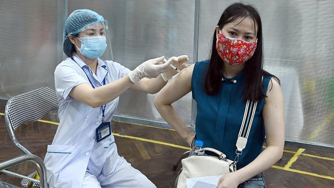 A woman is vaccinated against COVID-19.