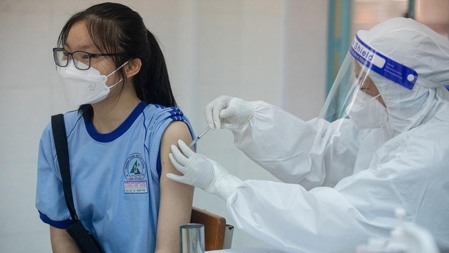 A student is vaccinated against COVID-19.