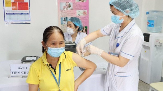 A woman is vaccinated against COVID-19.