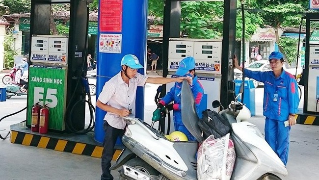 People buy petrol at a filling station in Dong Da District, Hanoi.