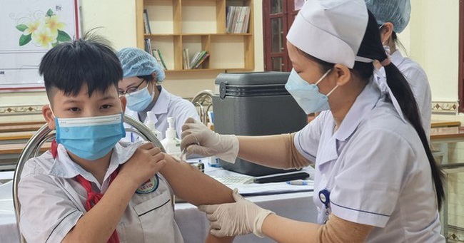 A boy is vaccinated against COVID-19.