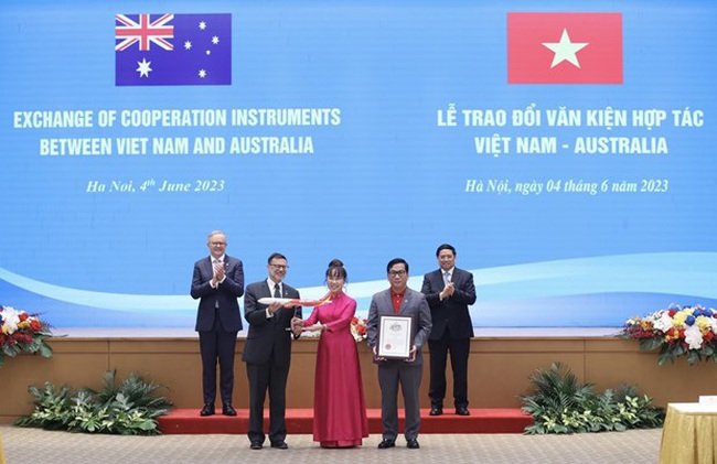 Vietjet President & Chairwoman Nguyen Thi Phuong Thao, Vietjet CEO Dinh Viet Phuong (red T-shirt, grey vest) receive the Testimonial of Appreciation in recognition of new direct route connecting Ho Chi Minh City and Brisbane under the witnesses of Prime Minister Pham Minh Chinh and his Australian counterpart, Anthony Albanese (Source: Vietjet).