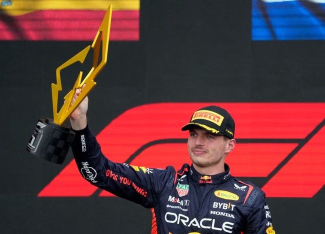 Red Bull's Max Verstappen celebrates with a trophy on the podium after winning the race (Photo: Reuters)