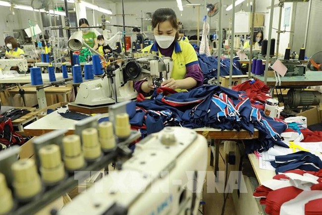 At a garment factory in Hanoi's outlying district of Dan Phuong. (Photo: VNA)