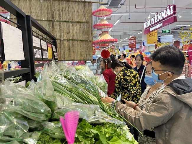 Consumers buy goods at a supermarket in HCM City. Local consumption is predicted to regain the spotlight in 2024. (Photo: VNA)