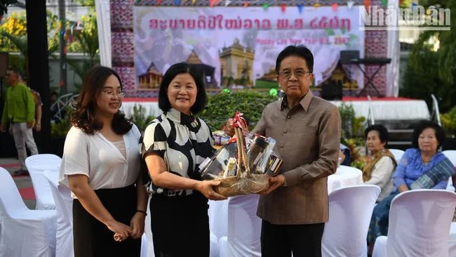 Chargé d'Affaires Bui Thi Hue presents a basket of traditional New Year gifts to Lao Ambassador Khamphan Anlavan on the afternoon of April 6. (Photo: XUAN SON)