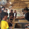 Children learn to make “Dzo” paper